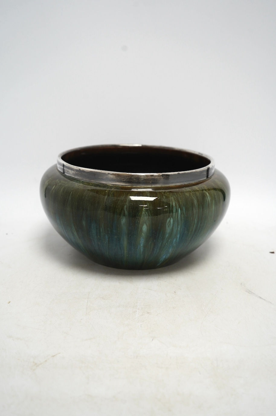A Christopher Dresser for Linthorpe pottery bowl, silver rimmed, stamped to the base, 24cm in diameter. Condition - good